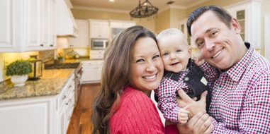 Family Smiling in a kitchen