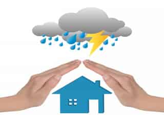 Two hands covering a home from a thunderstorm